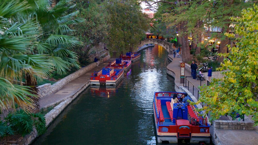 San Antonio River Walk with boats and scenic riverside paths lined with greenery.