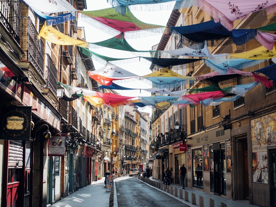 Colorful streets of El Rastro flea market in Madrid, bustling with activity.