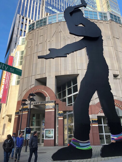 Exterior view of the Seattle Art Museum with the Hammering Man sculpture in downtown Seattle.