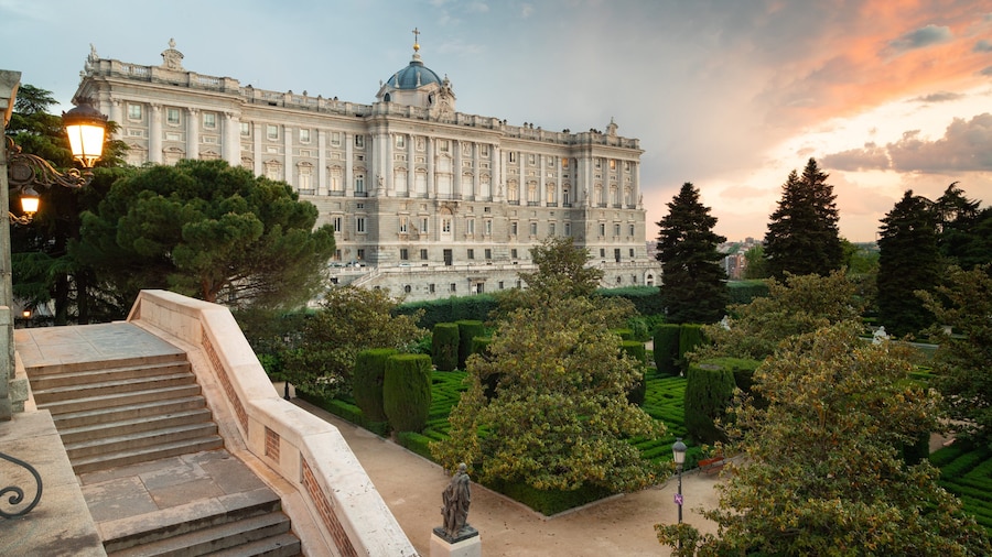 View of the Royal Palace of Madrid with its gardens at the sunset.