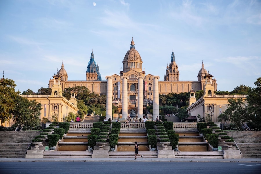 Front view of the National Art Museum of Catalonia (MNAC) in Barcelona, perched on Montjuïc hill with its grand stairways and classical architecture.