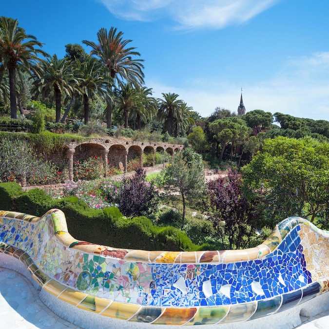 Lush gardens and architecture at Park Güell in Barcelona, designed by Antoni Gaudí.