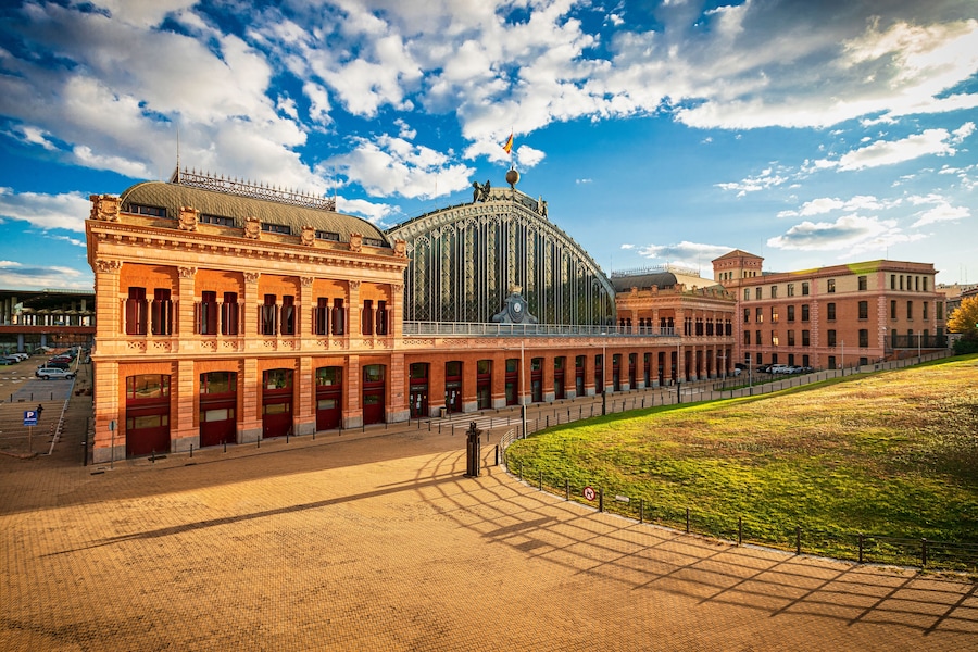 Exterior view of Atocha Station in Madrid, showcasing its historic architecture.