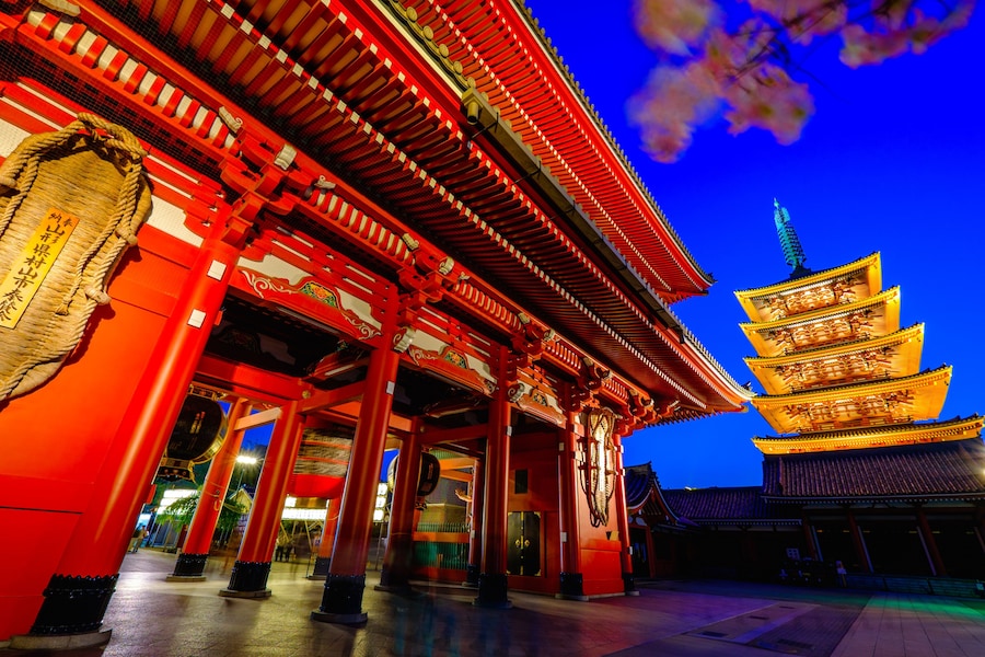 Senso-ji Temple's iconic red gate and pagoda illuminated at night in Asakusa, Tokyo.