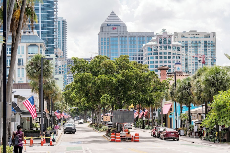 Las Olas Boulevard with shops, restaurants, and greenery in Fort Lauderdale, Florida.
