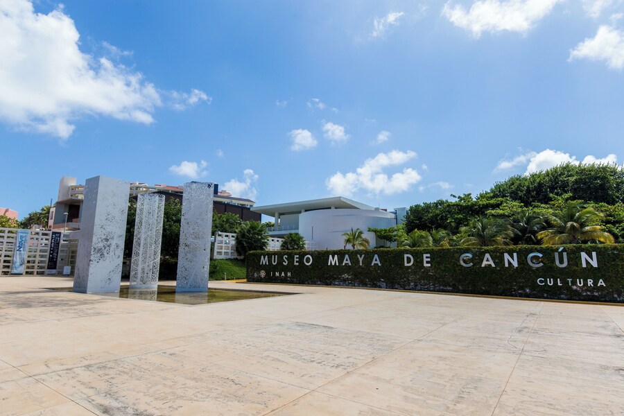 Entrance of Museo Maya de Cancun with modern architecture and outdoor space.