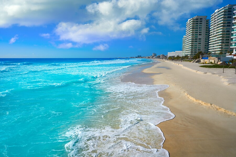 Turquoise waters and vibrant atmosphere at Playa Forum in Cancun, Mexico.