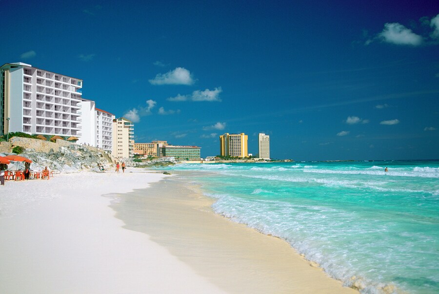 Wide sandy shores and turquoise waters at Playa Marlin in Cancun, Mexico.