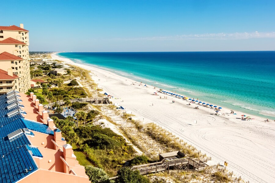 Aerial view of Crystal Beach with white sands and emerald waters in Destin, Florida.