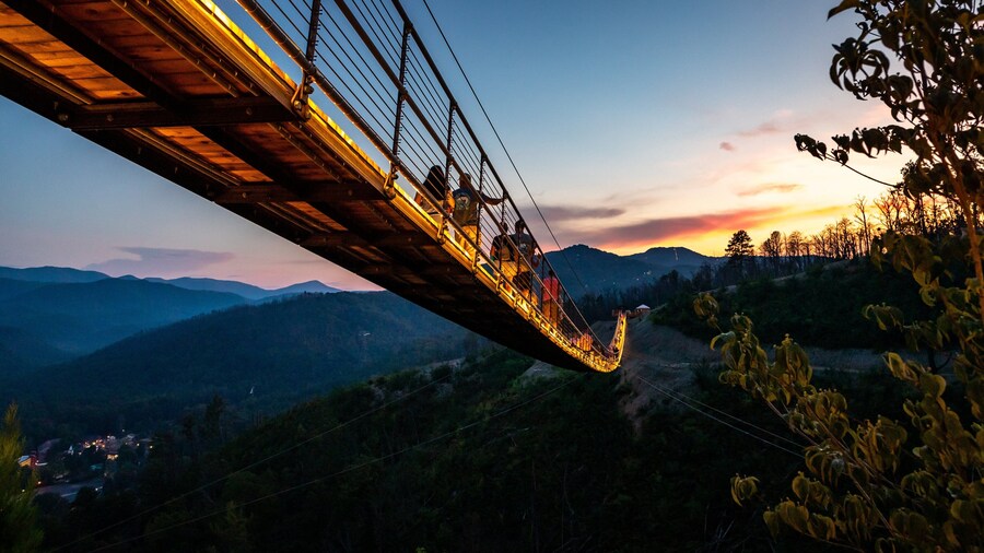 Gatlinburg SkyBridge at sunset with panoramic mountain views and glass-floor section.