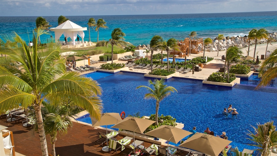 Luxury resort with turquoise waters and palm trees in Cancun's Zona Hotelera.